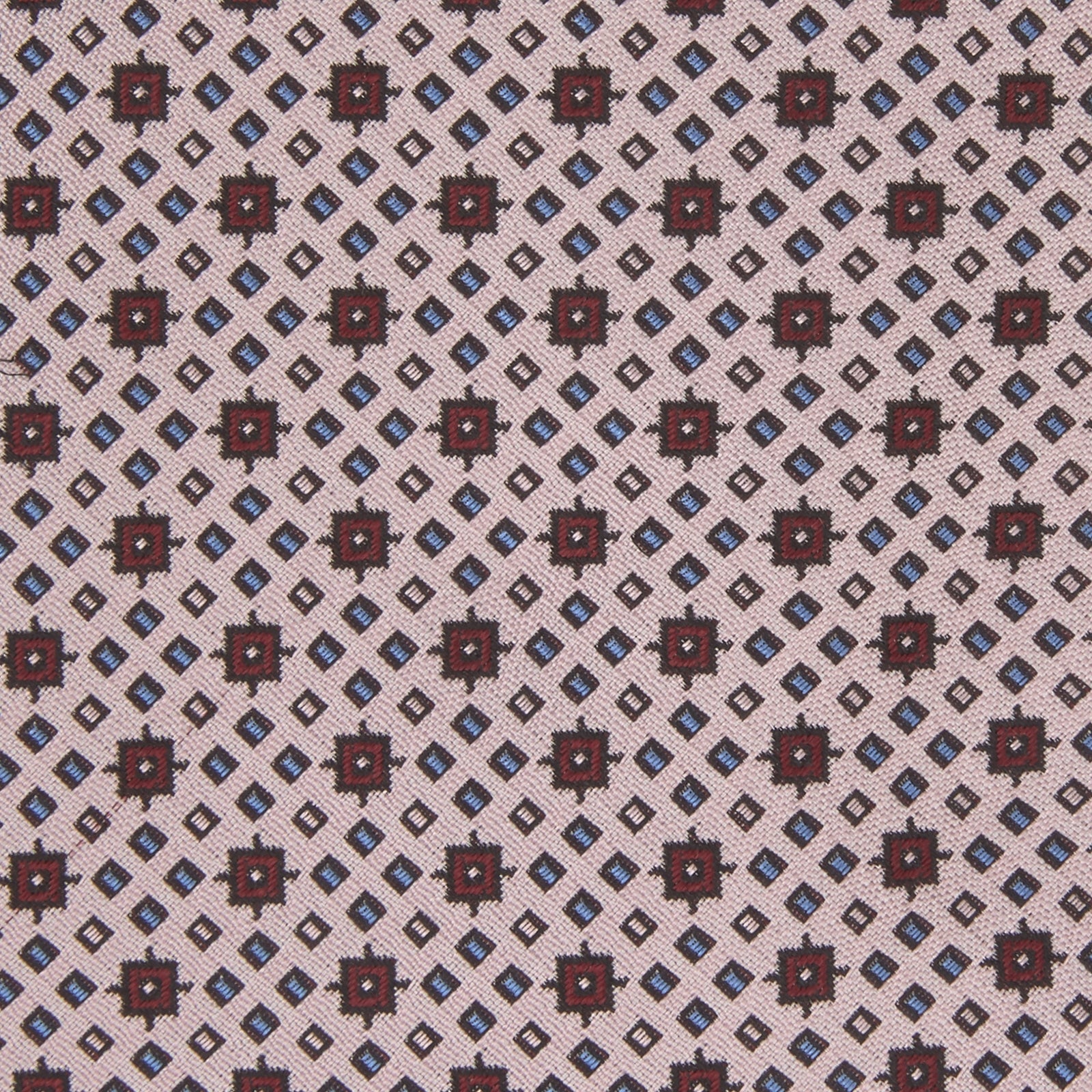 View 3 of product The Turnbull & Asser Pastel Pink Geometric Silk Tie features a small, repeating dark brown and white pattern for a mid-century look—ideal with tailored jackets. Shown rolled up on a white background.