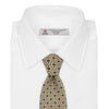 View 2 of product The Turnbull & Asser Pale Yellow Geometric Silk Tie features a subtle navy blue floral pattern and is displayed rolled on a white background.