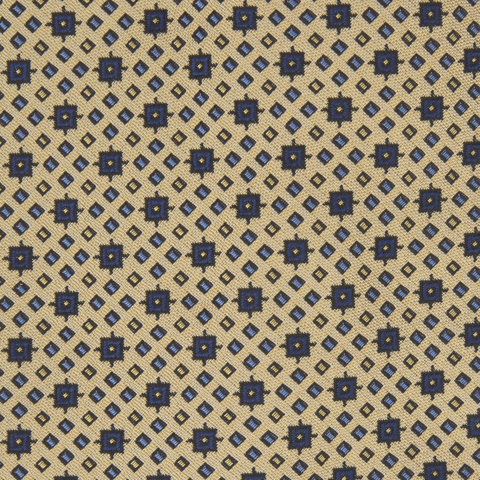 View 3 of product The Turnbull & Asser Pale Yellow Geometric Silk Tie features a subtle navy blue floral pattern and is displayed rolled on a white background.