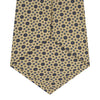 View 4 of product The Turnbull & Asser Pale Yellow Geometric Silk Tie features a subtle navy blue floral pattern and is displayed rolled on a white background.