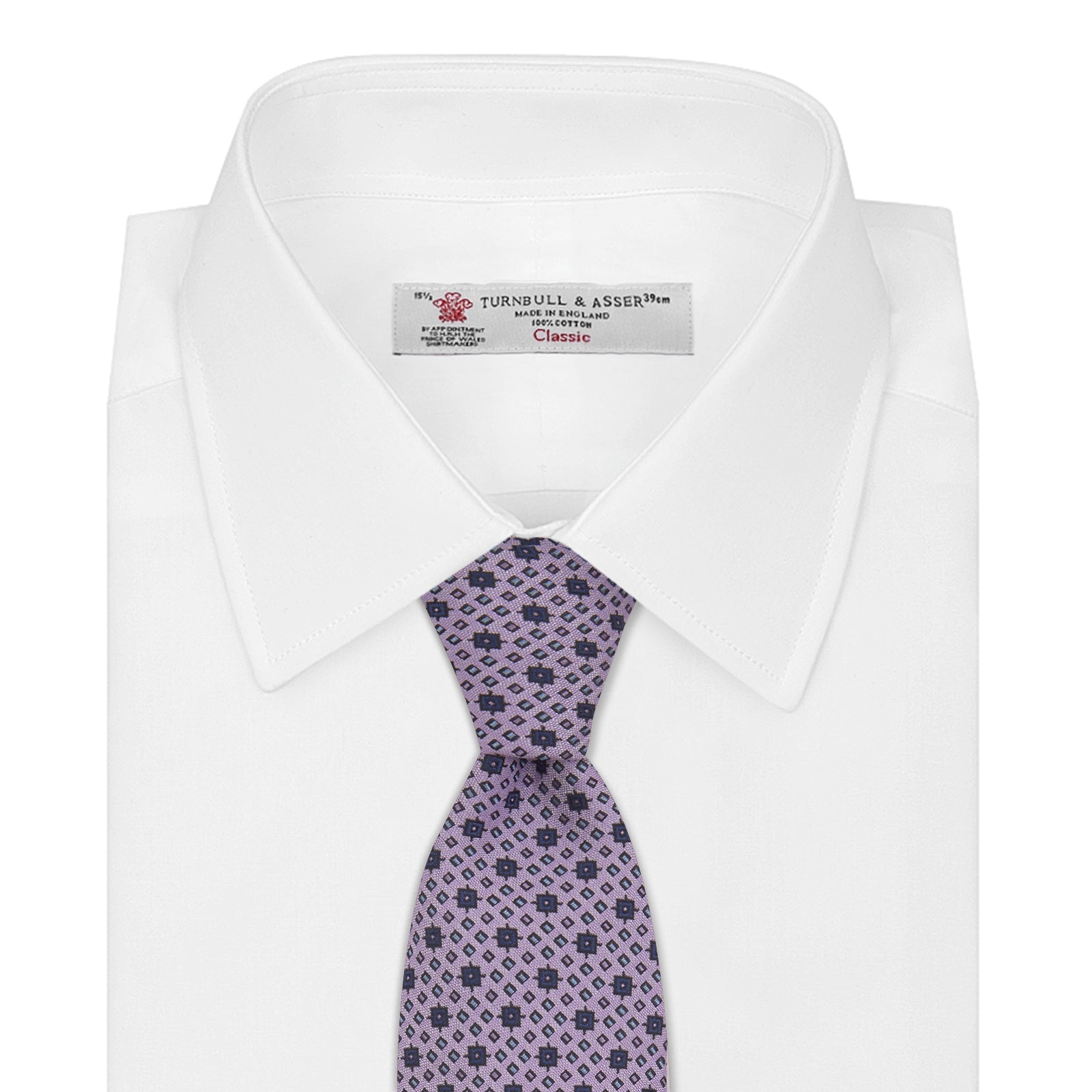 View 2 of product The Turnbull & Asser Lilac Geometric Silk Tie features a small, repeating mid-century motif in dark purple and black on white—an ideal accent for tailored jackets.