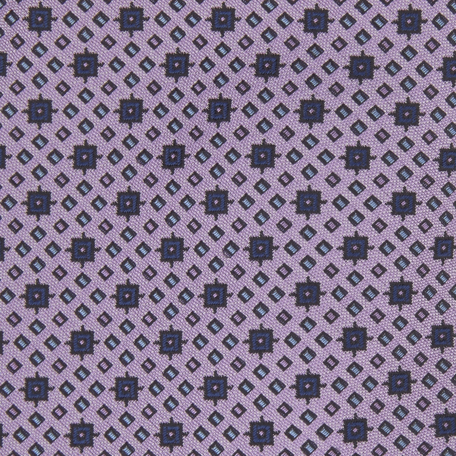 View 3 of product The Turnbull & Asser Lilac Geometric Silk Tie features a small, repeating mid-century motif in dark purple and black on white—an ideal accent for tailored jackets.