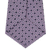 View 4 of product The Turnbull & Asser Lilac Geometric Silk Tie features a small, repeating mid-century motif in dark purple and black on white—an ideal accent for tailored jackets.