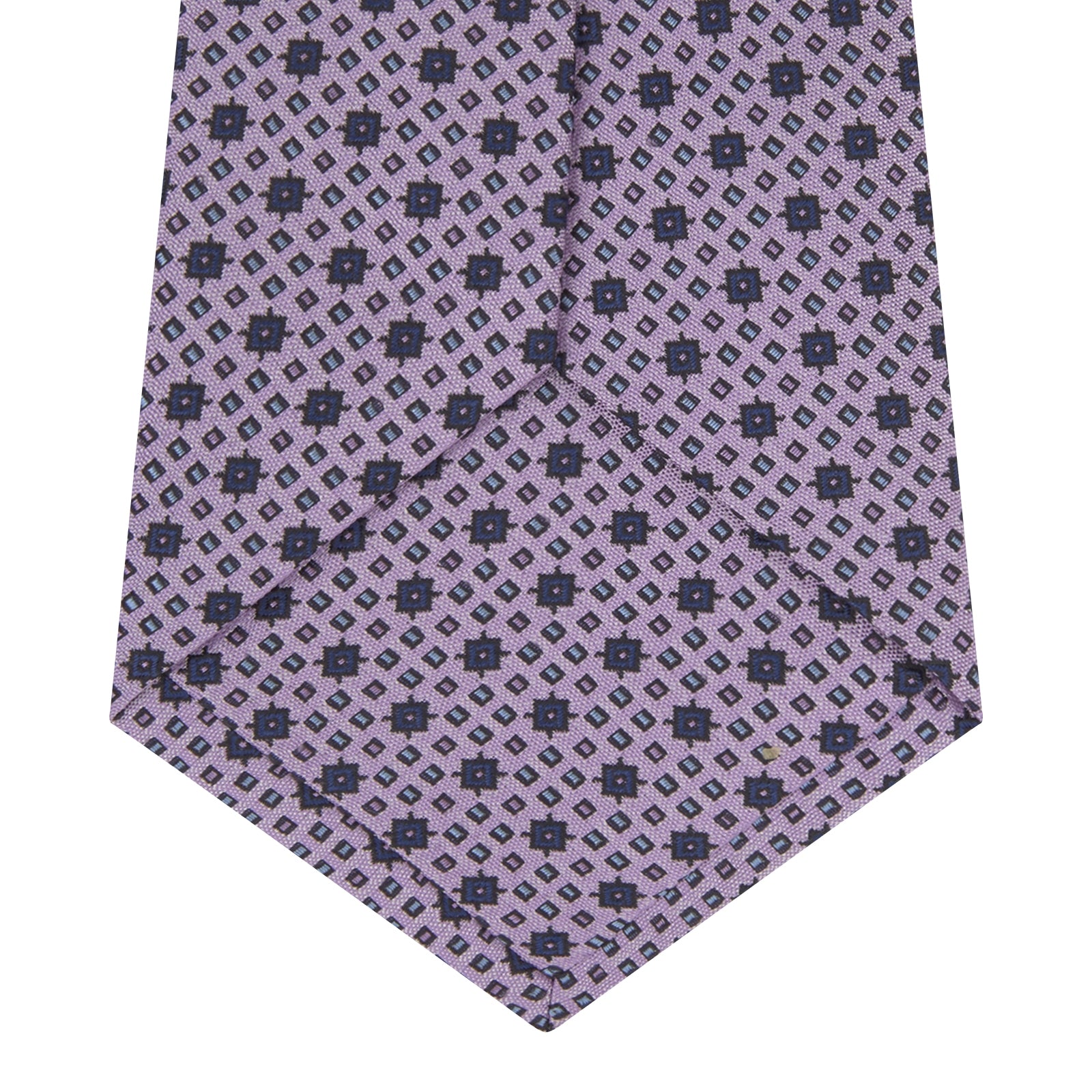 View 4 of product The Turnbull & Asser Lilac Geometric Silk Tie features a small, repeating mid-century motif in dark purple and black on white—an ideal accent for tailored jackets.
