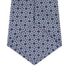 View 4 of product The Turnbull & Asser Sky Blue Geometric Silk Tie features a mid-century dark blue and maroon motif on light blue silk, shown against a white background—ideal for pairing with tailored jackets.