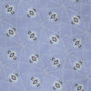 View 3 of product The Turnbull & Asser Sky Blue Star Flowers Silk Tie features a small white and dark blue square and star flower pattern on jacquard silk, shown rolled up against a plain white background.