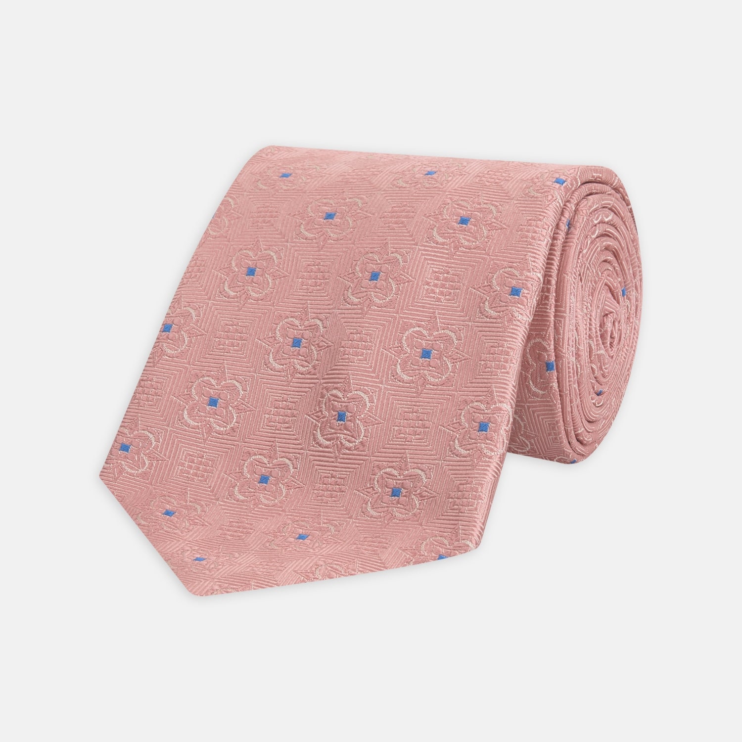 View 1 of product The Pink Flower Mosaic Silk Tie by Turnbull & Asser features a subtle jacquard texture with small blue floral accents, shown on a white background.