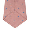View 4 of product The Pink Flower Mosaic Silk Tie by Turnbull & Asser features a subtle jacquard texture with small blue floral accents, shown on a white background.