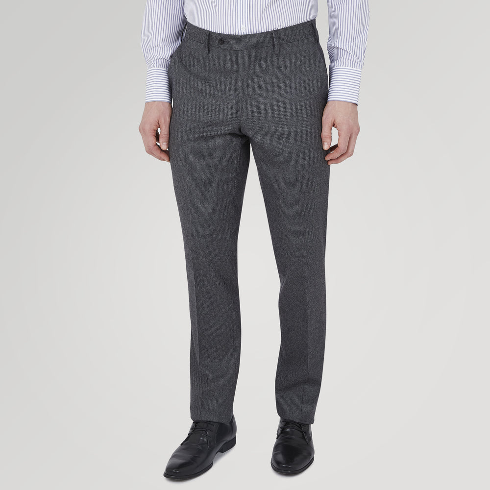The Turnbull & Asser Jackson Grey Flannel Wool Trousers feature a tailored fit with button and zipper closure, crafted from premium wool flannel for a refined look, shown against a plain white background.