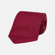 The Turnbull & Asser Burgundy and White Small Spot Printed Silk Tie, shown rolled against a plain white background, is an elegant accessory ideal for the office.