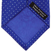 View 4 of product The Turnbull & Asser Slim Royal Blue and White Small Spot Printed Silk Tie, featuring white polka dots, is ideal for office wear and shown rolled up on a plain white background.