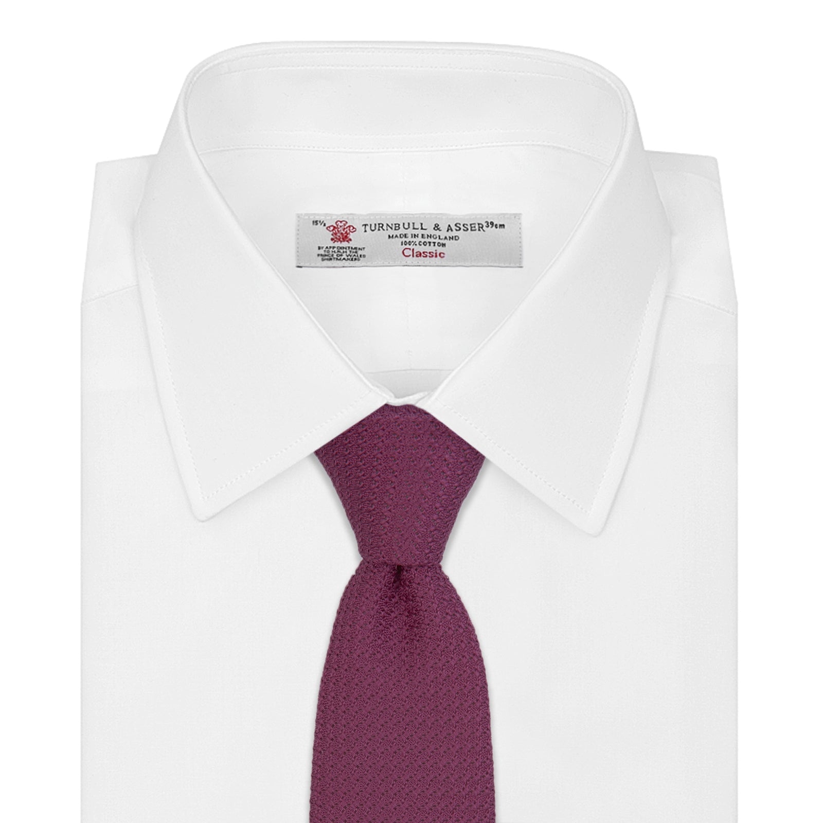 View 2 of product The Turnbull & Asser Wine Grenadine Silk Tie, featuring a textured weave in dark purple, is displayed rolled-up on a plain white background.