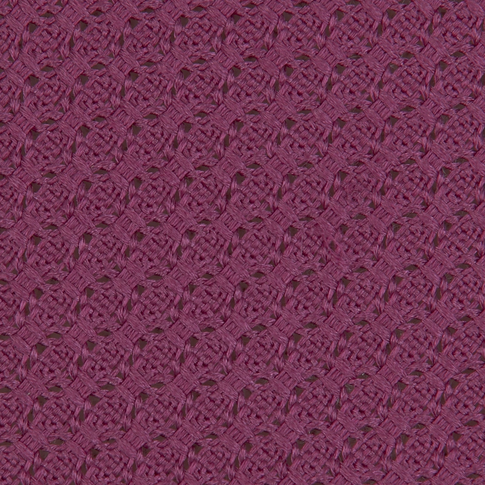 View 3 of product The Turnbull & Asser Wine Grenadine Silk Tie, featuring a textured weave in dark purple, is displayed rolled-up on a plain white background.