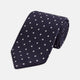 The Seven-Fold Navy Churchill Spot Silk Tie by Turnbull & Asser features evenly spaced white polka dots on navy silk—a luxury neckwear piece rolled up and displayed on a white background.