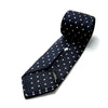 View 4 of product The Seven-Fold Navy Churchill Spot Silk Tie by Turnbull & Asser features evenly spaced white polka dots on navy silk—a luxury neckwear piece rolled up and displayed on a white background.