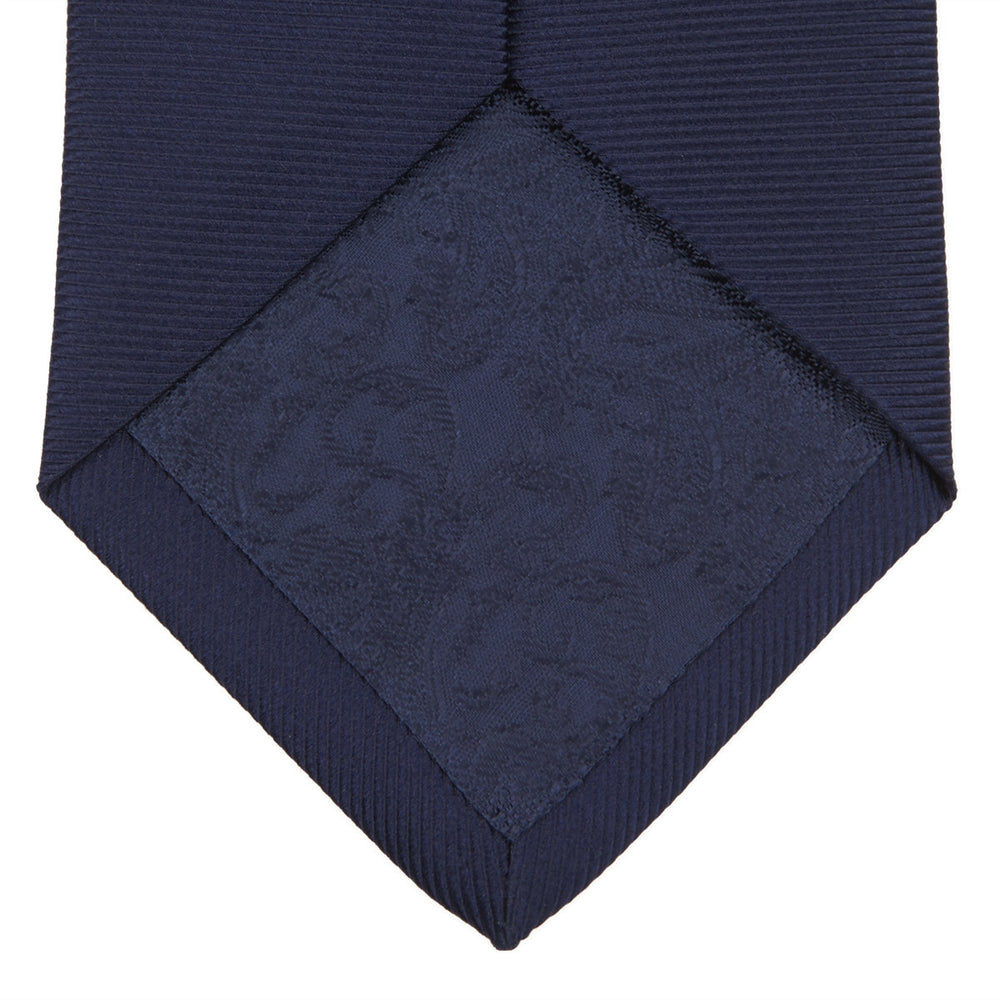 The Slim Navy Twill Silk Tie by Turnbull & Asser features a classic textured design—perfect with a cotton shirt—neatly displayed on a white background.