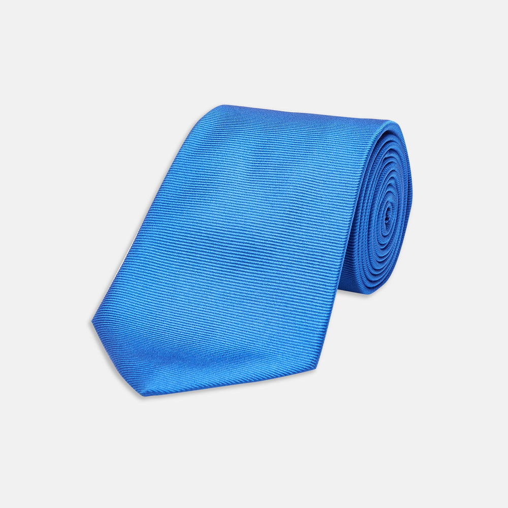 The Turnbull & Asser Slim Royal Blue Twill Silk Tie features a refined twill texture in bright blue, displayed on a white background—an ideal smart accent to pair with cotton shirts.