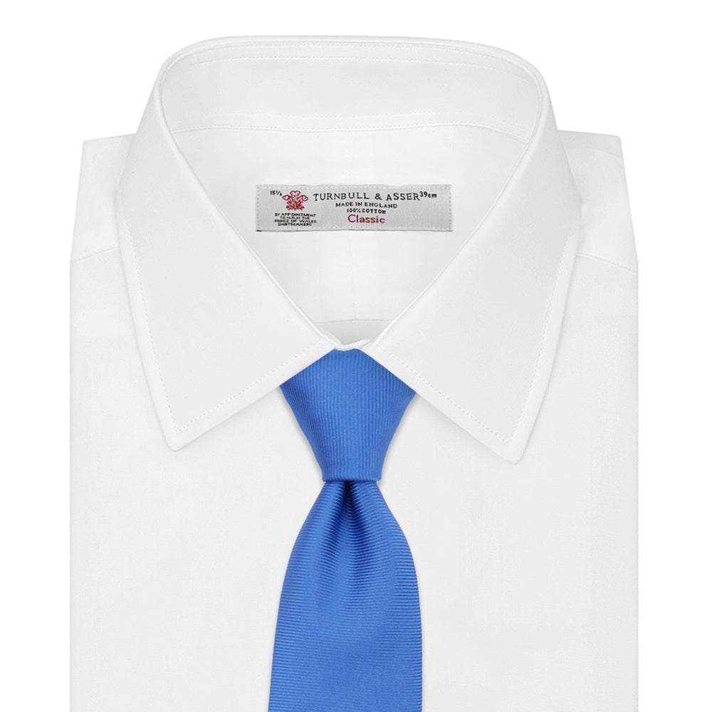 The Turnbull & Asser Slim Royal Blue Twill Silk Tie features a refined twill texture in bright blue, displayed on a white background—an ideal smart accent to pair with cotton shirts.