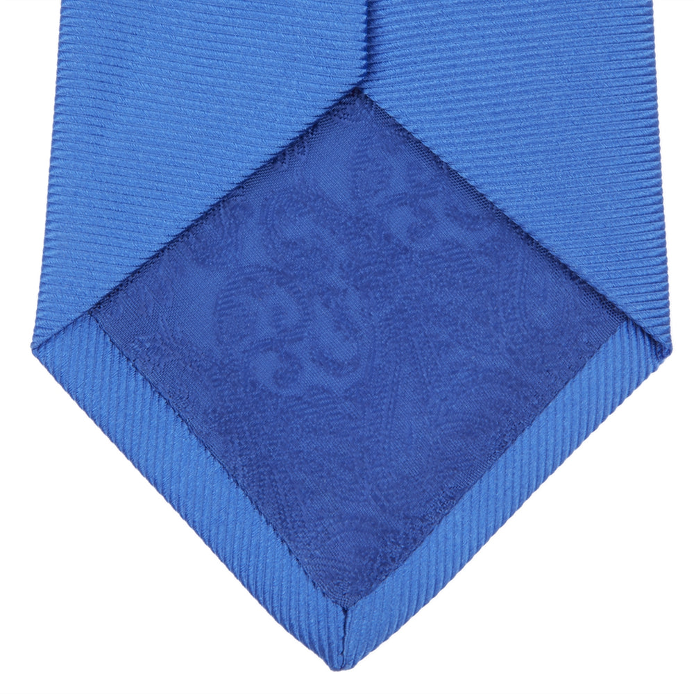 The Turnbull & Asser Slim Royal Blue Twill Silk Tie features a refined twill texture in bright blue, displayed on a white background—an ideal smart accent to pair with cotton shirts.