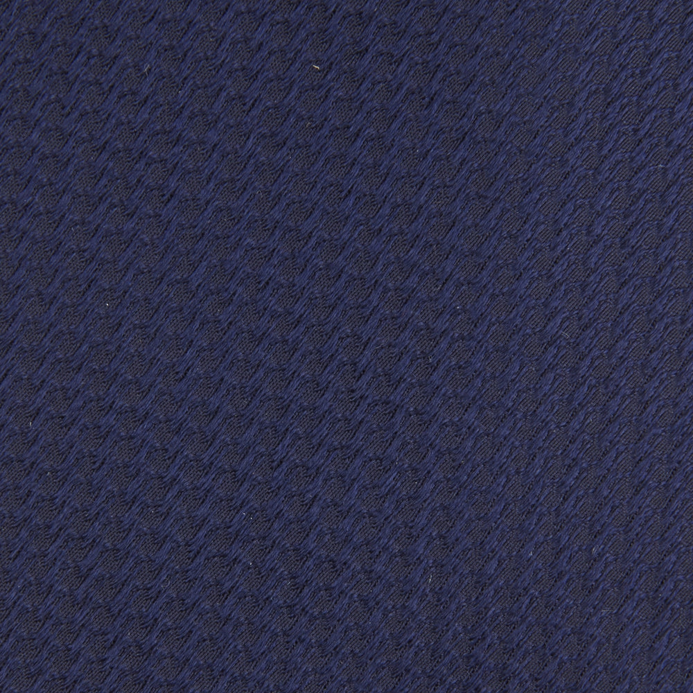 A close-up of the Turnbull & Asser Long Navy Lace Silk Tie, featuring a subtle lace weave texture, rolled up and displayed on a plain white background.