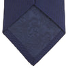 View 4 of product A close-up of the Turnbull & Asser Long Navy Lace Silk Tie, featuring a subtle lace weave texture, rolled up and displayed on a plain white background.