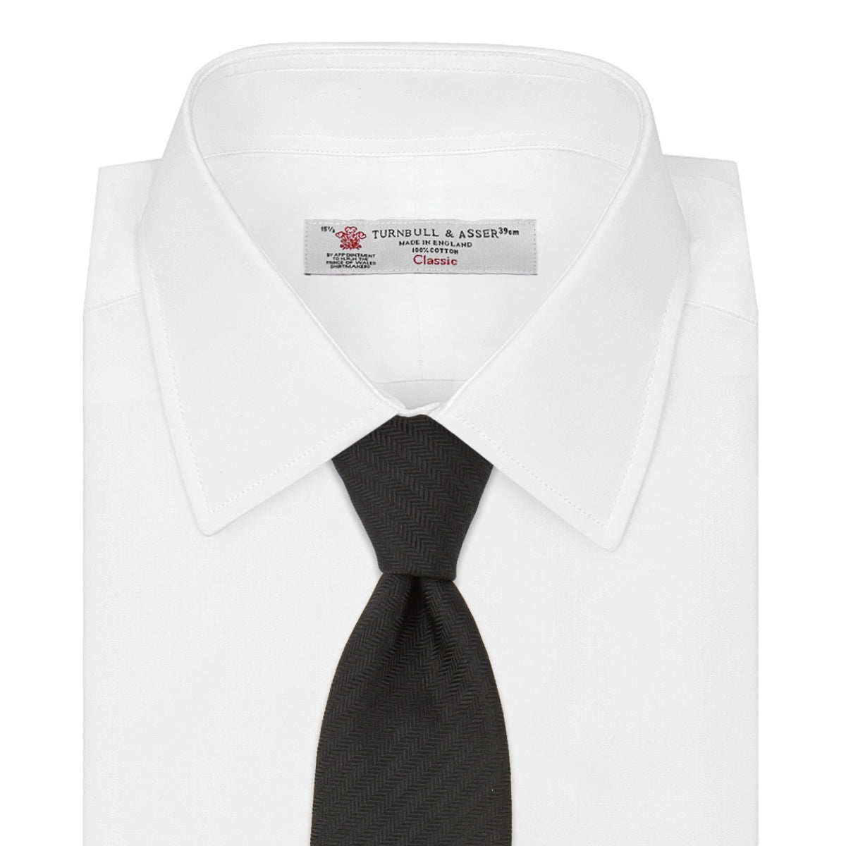 View 2 of product The Turnbull & Asser Slim Black Herringbone Silk Tie is neatly rolled, showcasing its subtle weave on a plain white background.