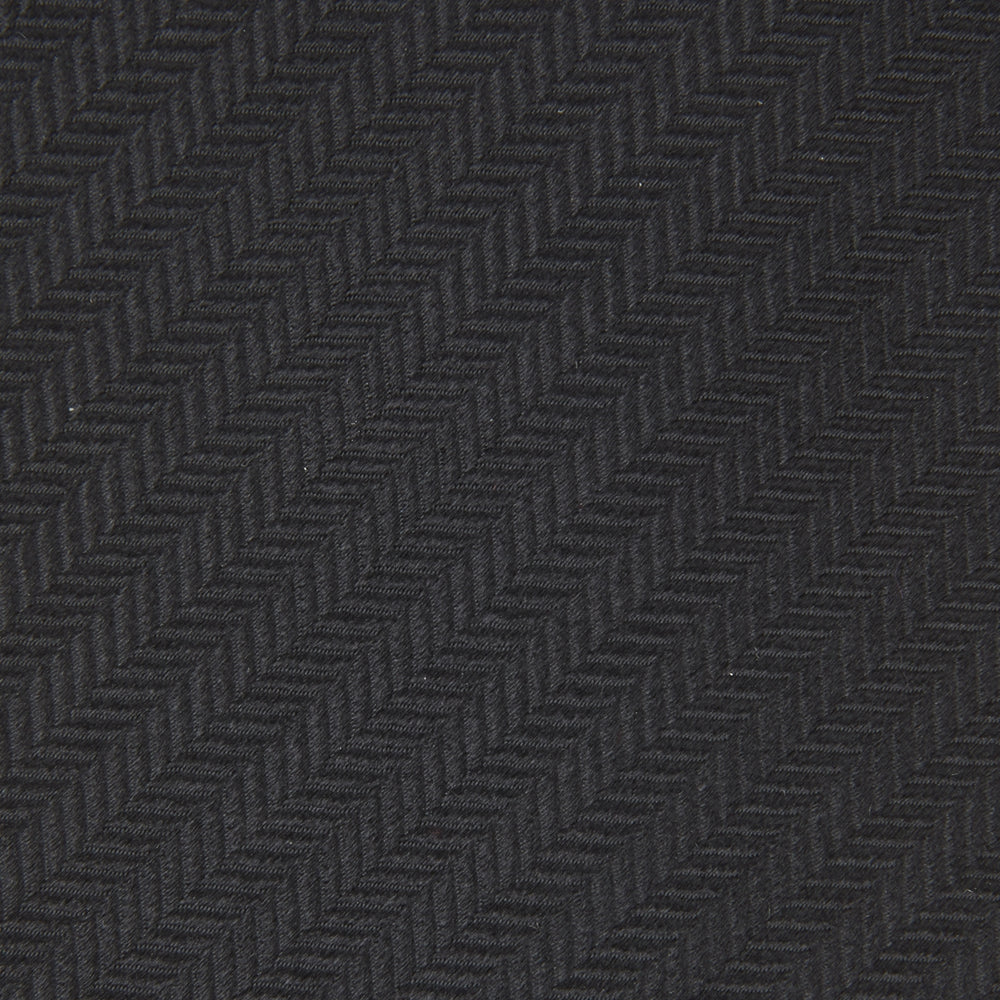 The Turnbull & Asser Seven-Fold Black Herringbone Silk Tie, featuring a subtle weave, is shown rolled up against a plain white background.