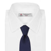 View 2 of product The Turnbull & Asser Long Navy Plain Satin Silk Tie is neatly rolled and displayed against a plain white background.