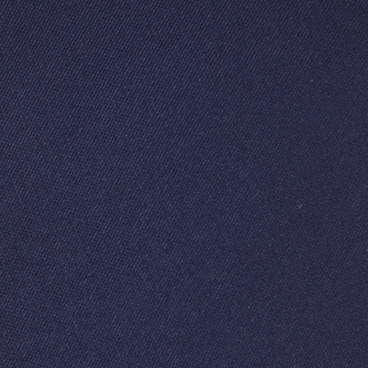 View 3 of product The Turnbull & Asser Seven-Fold Navy Plain Satin Silk Tie is neatly rolled and showcased against a plain light gray background.