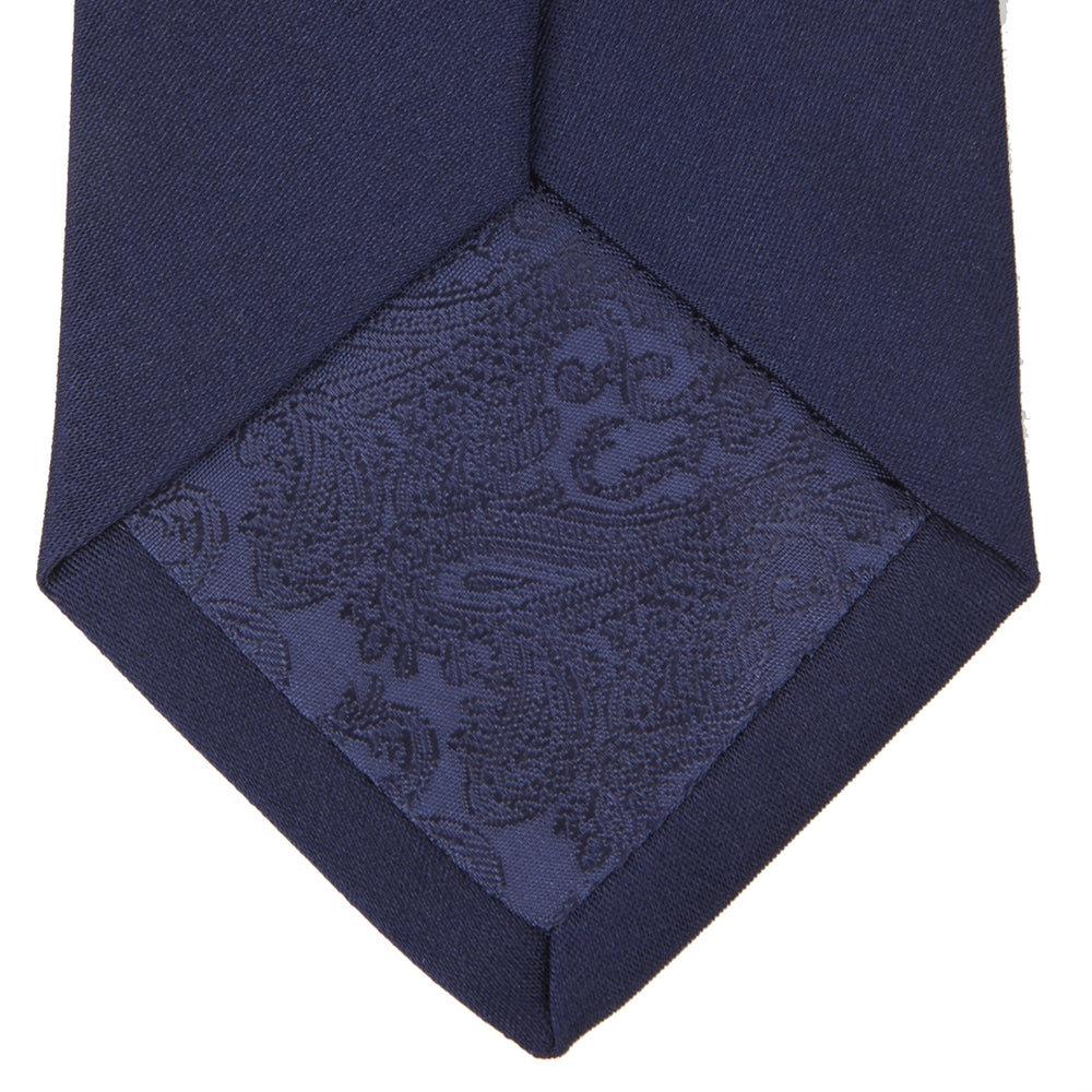 The Turnbull & Asser Long Navy Plain Satin Silk Tie is neatly rolled and displayed against a plain white background.