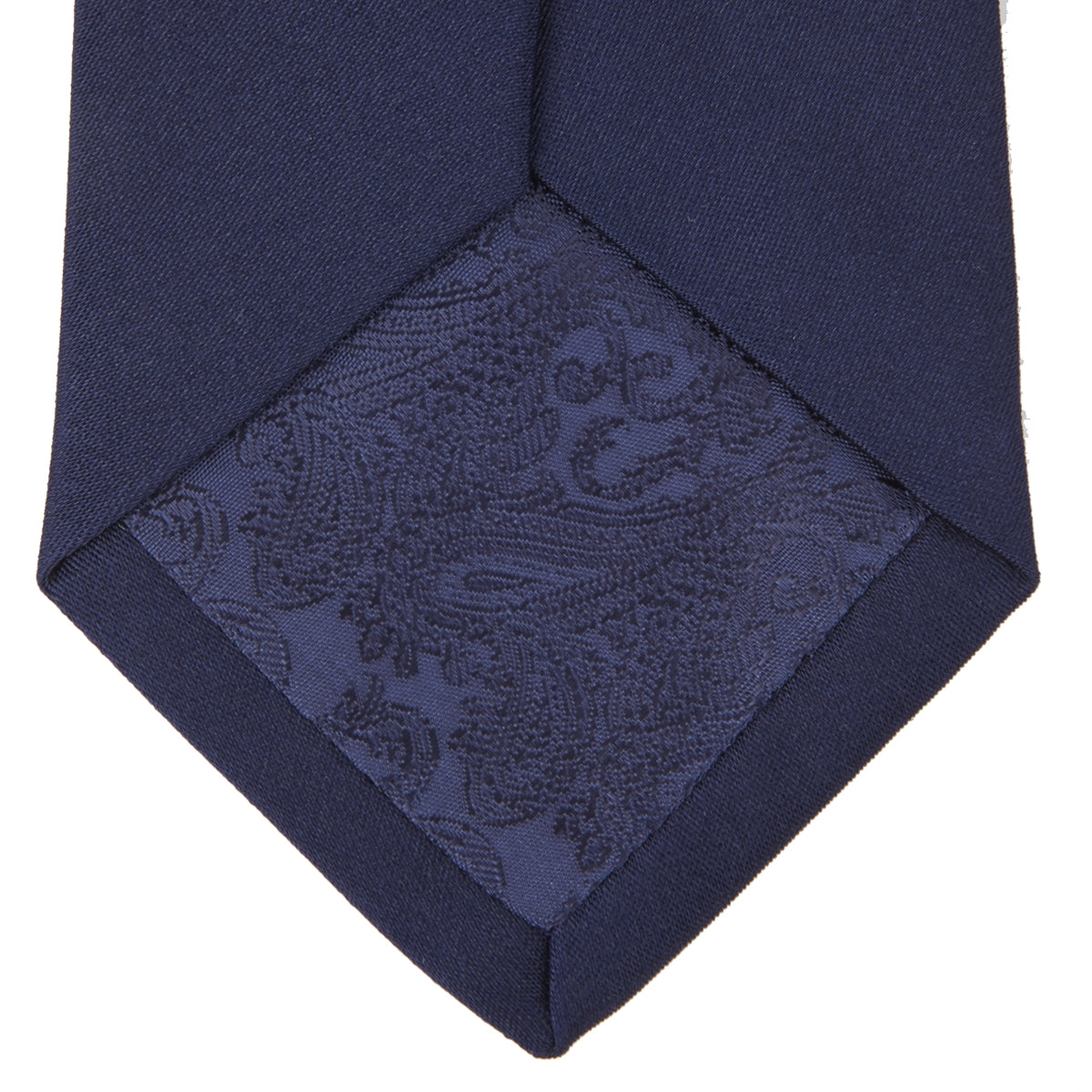 View 4 of product The Turnbull & Asser Long Navy Plain Satin Silk Tie is neatly rolled and displayed against a plain white background.