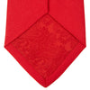 View 4 of product A Red Plain Satin Silk Tie by Turnbull & Asser is neatly rolled and displayed against a plain light gray background.