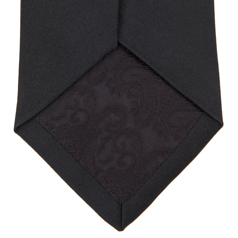 The Turnbull & Asser Black Plain Satin Silk Tie, neatly rolled and shown on a white background, adds versatile elegance to any formal outfit.