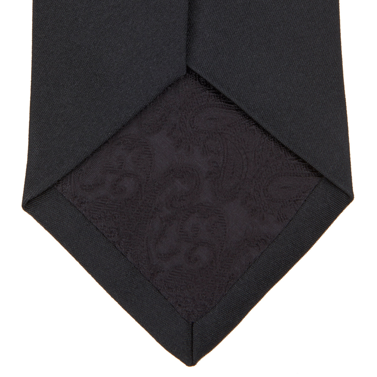 View 4 of product The Turnbull & Asser Black Plain Satin Silk Tie, neatly rolled and shown on a white background, adds versatile elegance to any formal outfit.