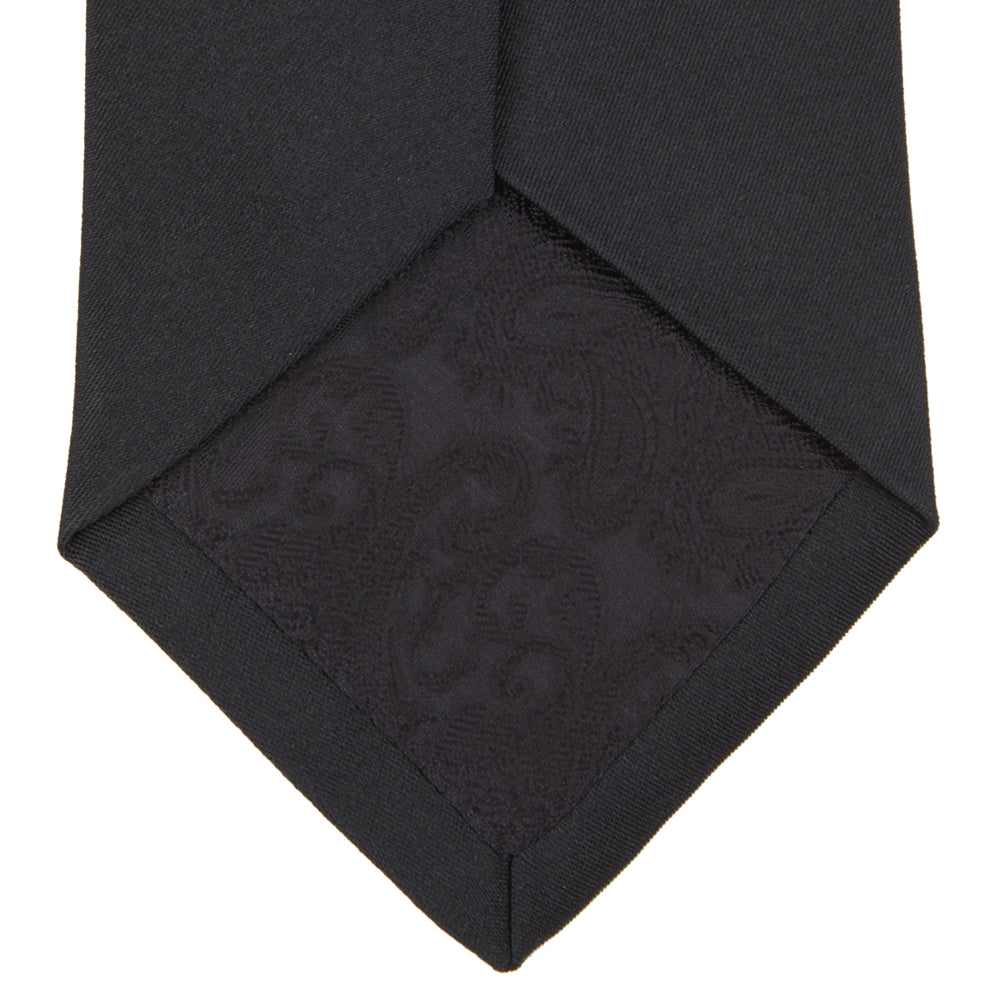 The Turnbull & Asser Slim Black Plain Satin Silk Tie is neatly rolled on a white background—an essential accessory for smart dress and formal occasions.