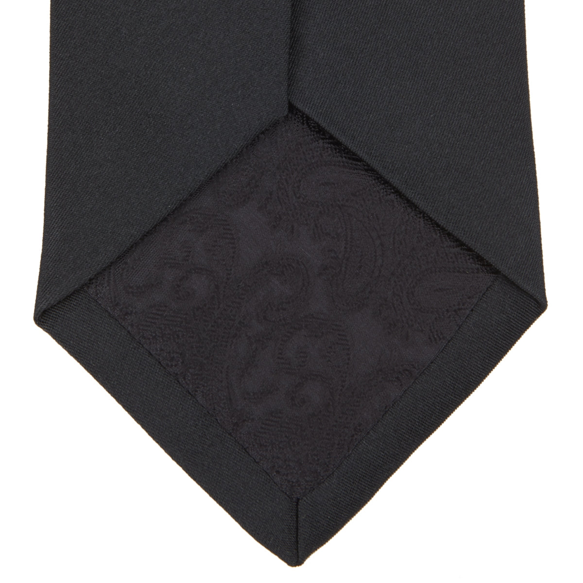 View 4 of product The Turnbull & Asser Slim Black Plain Satin Silk Tie is neatly rolled on a white background—an essential accessory for smart dress and formal occasions.