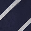 View 4 of product The Turnbull & Asser Long Navy and White Blazer Stripe Repp Silk Tie is shown rolled at one end, highlighting its diagonal stripes, against a plain white background.