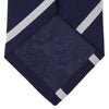 View 4 of product The Turnbull & Asser Navy and White Blazer Stripe Repp Silk Tie is shown rolled up on a plain white background—an ideal accessory to complement any office shirt.