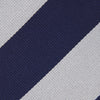View 4 of product The Long Navy and Off-White Block Stripe Repp Silk Tie by Turnbull & Asser, featuring diagonal stripes, is rolled up and displayed on a plain white background—ideal for pairing with an office shirt.
