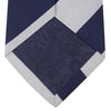 View 3 of product The Long Navy and Off-White Block Stripe Repp Silk Tie by Turnbull & Asser, featuring diagonal stripes, is rolled up and displayed on a plain white background—ideal for pairing with an office shirt.
