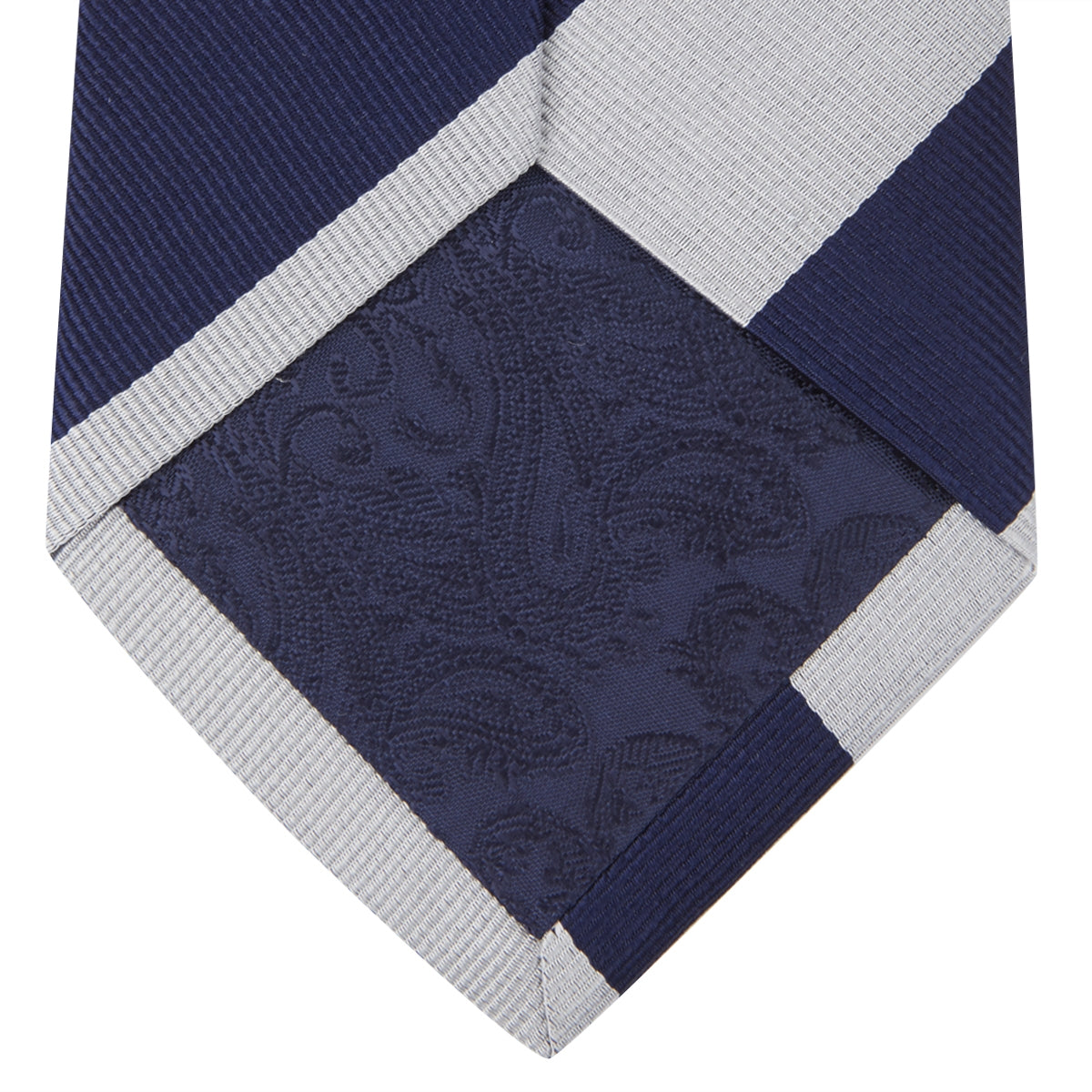 View 3 of product The Long Navy and Off-White Block Stripe Repp Silk Tie by Turnbull & Asser, featuring diagonal stripes, is rolled up and displayed on a plain white background—ideal for pairing with an office shirt.