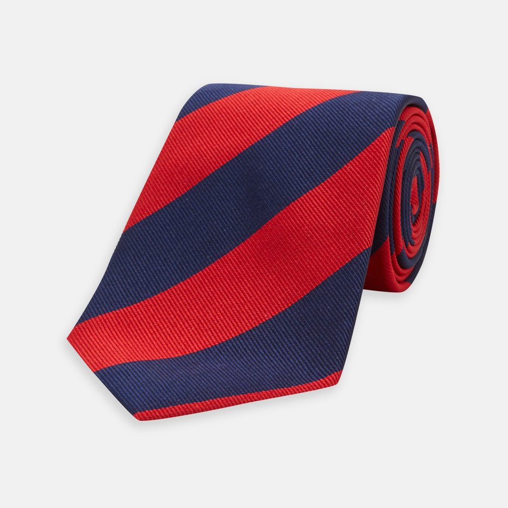 The Navy and Red Block Stripe Repp Silk Tie by Turnbull & Asser features bold diagonal red and navy stripes on a crisp white background.