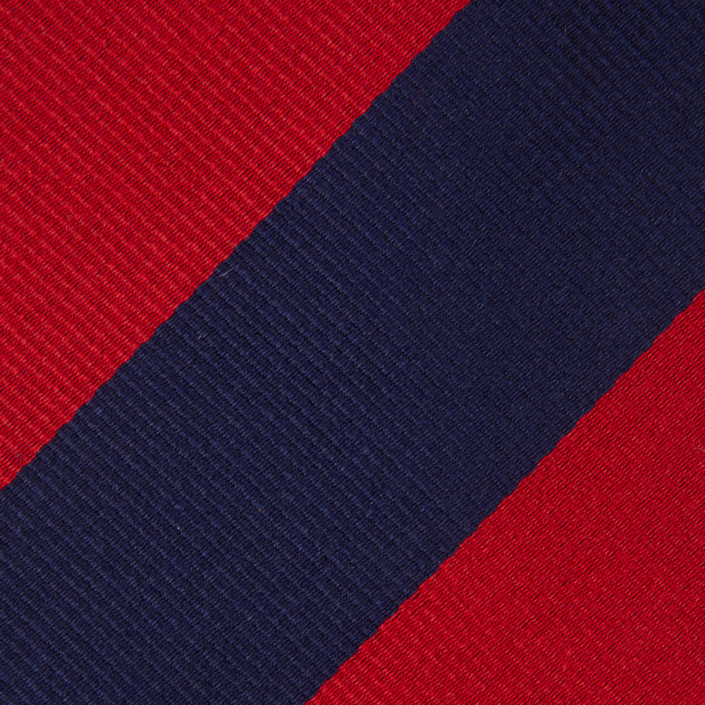 The Navy and Red Block Stripe Repp Silk Tie by Turnbull & Asser features bold diagonal red and navy stripes on a crisp white background.