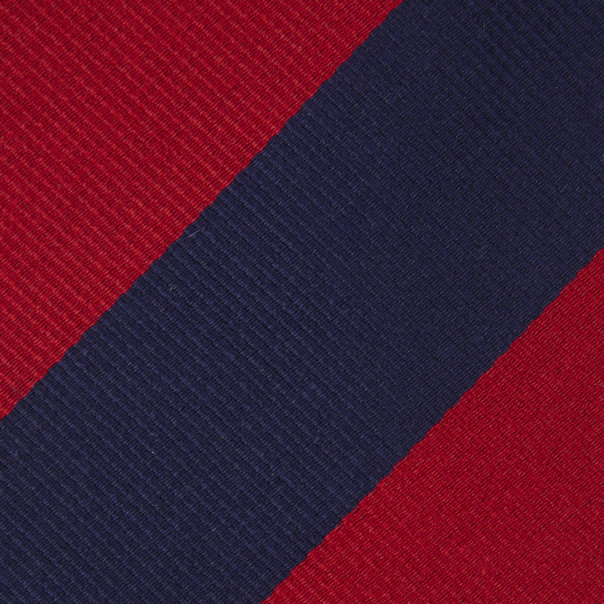 View 3 of product The Turnbull & Asser Long Navy and Red Block Stripe Repp Silk Tie features bold diagonal stripes on white—an ideal office shirt companion.