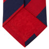 View 4 of product The Navy and Red Block Stripe Repp Silk Tie by Turnbull & Asser features bold diagonal red and navy stripes on a crisp white background.