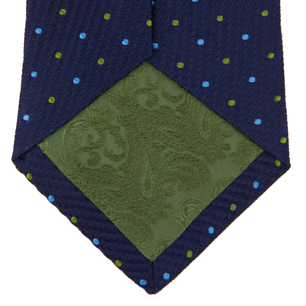The Turnbull & Asser Navy, Blue & Green Spot Lace Silk Tie features small, evenly spaced blue and green spots—perfect for adding a refined touch to your favorite office shirt.