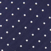 View 4 of product The Turnbull & Asser Seven-Fold Navy & White Spot Herringbone Silk Tie features a navy base with white polka dots and a classic herringbone weave, displayed rolled up on a plain white background.