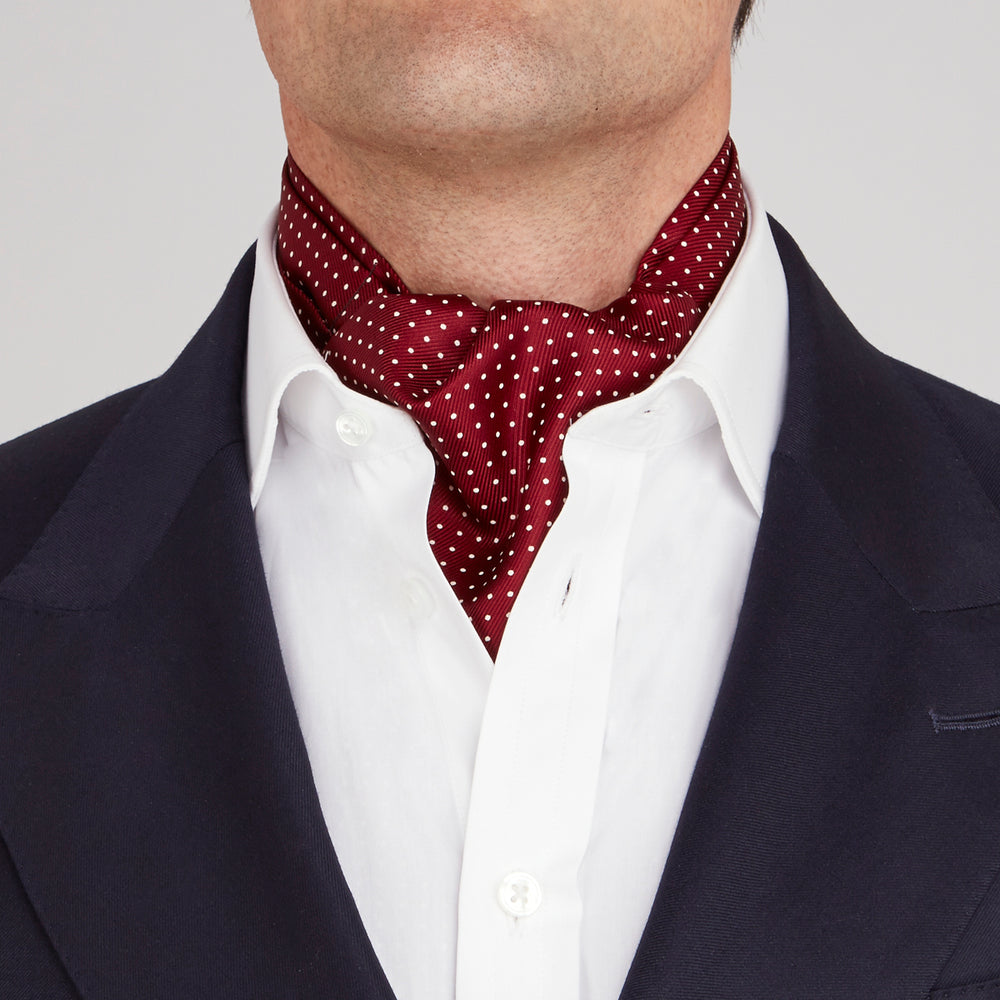 The Burgundy and White Mini Spot Silk Cravat by Turnbull & Asser adds refined detail—ideal neckwear for wedding guests, especially paired with a matching maroon pocket square.