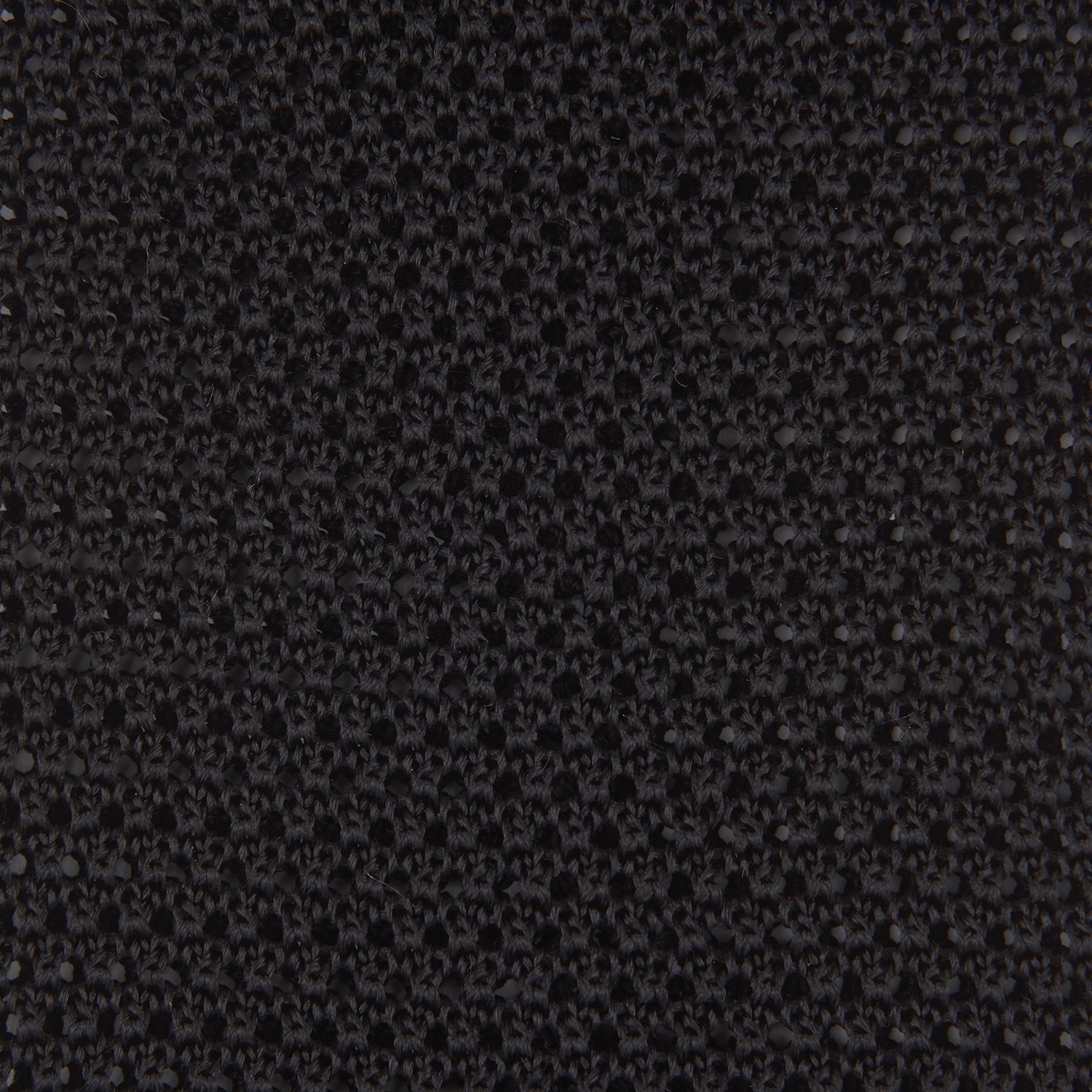 View 3 of product The Turnbull & Asser Black Knitted Silk Tie features a textured pattern and is displayed rolled up on a white background—a stylish, versatile accessory perfect for elevating any gentleman's wardrobe.