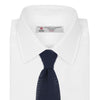 View 2 of product The Turnbull & Asser Navy Knitted Silk Tie features a textured open weave and flat squared ends, making it a versatile accessory for the modern gentleman’s wardrobe. Shown rolled up on a plain white background.